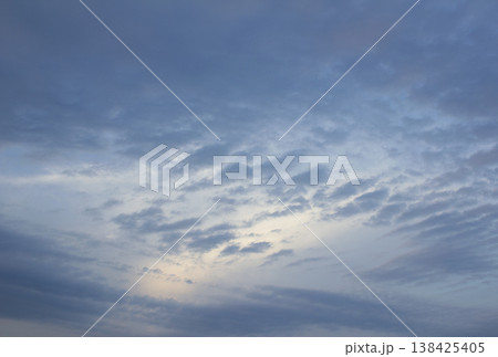 It is a sunset sky with flocks of clouds. 138425405