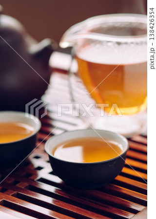 Teapot and cups with Chinese tea on the table Teapot and cups with Chinese tea on the table 138426354