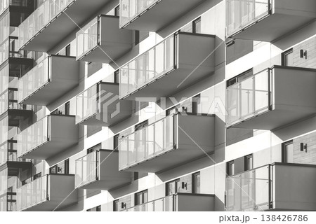 Modern residential building with balconies shown from a street-level perspective. Contemporary Modern residential building with balconies shown from a street-level perspective. Contemporary 138426786