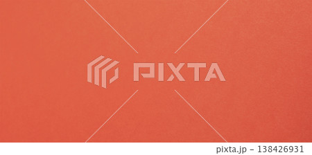 Vivid orange red paper, background with refined warmth. Smooth satin surface shows subtle metallic 138426931