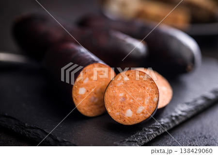 Smoked Sausage With Dark Casing Sliced Closeup on Rustic Surface, Deli Meat Appetizer Smoked Sausage With Dark Casing Sliced Closeup on Rustic Surface, Deli Meat Appetizer 138429060
