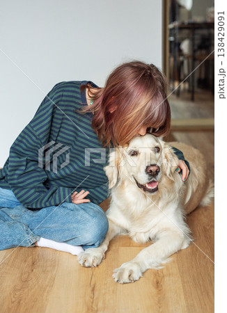 Young girl bonding with golden retriever dog companion 138429091