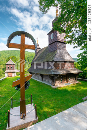 likitsary, ukraine - 02 july 2020: church in traditional orthodox wooden architecture of europe. summer countryside scenery in carpathian mountains near the slovakia border. cloudy sky. vertical view 138429598