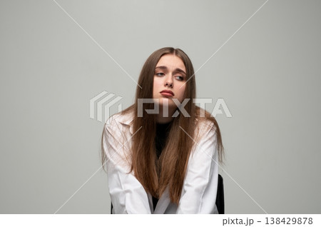 Young mournful woman feeling isolated, experiencing negative emotions, looking away with a gloomy expression 138429878