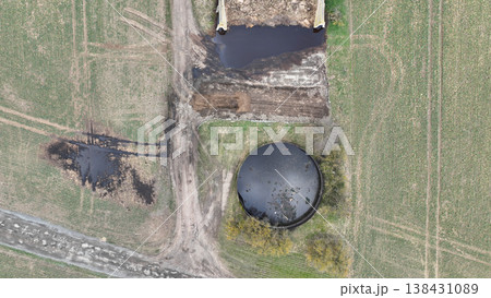 Manure lagoon storage tank pit submerged slurry collect and store liquid livestock pollution contamination groundwater solid waste bedding straw or corn stalks stored pile stinking unpleasant smell Manure lagoon storage tank pit submerged slurry collect and store liquid livestock pollution contamination groundwater solid waste bedding straw or corn stalks stored pile stinking unpleasant smell 138431089