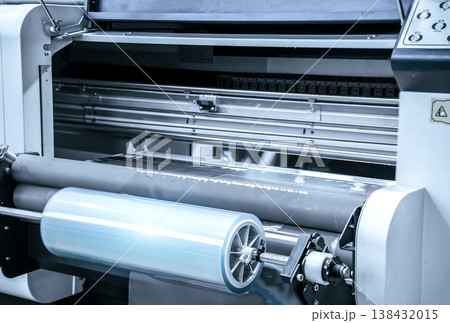 Industrial Laminating and rewinding kind of protective film machine with clamping rollers automatic edge banding in a bustling factory setting. Industrial Laminating and rewinding kind of protective film machine with clamping rollers automatic edge banding in a bustling factory setting. 138432015