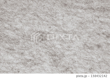 Macro photo of dark grey felt texture with a melange effect. The close-up reveals tangled wool fibers and a soft, matte, non woven surface with an industrial aesthetic Macro photo of dark grey felt texture with a melange effect. The close-up reveals tangled wool fibers and a soft, matte, non woven surface with an industrial aesthetic 138432142