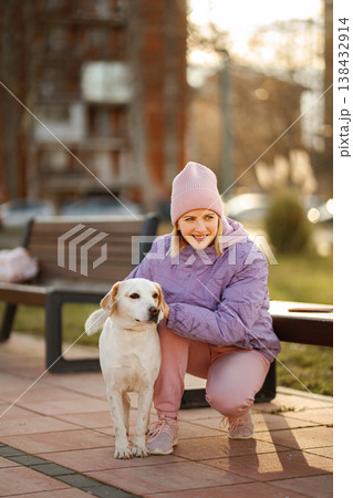 Young woman enjoying connection with her dog in urban parc 138432914