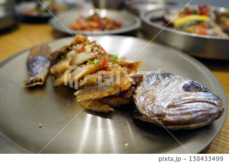 Korean traditional barley-aged dried croaker (Bori-gulbi) served on a brass plate 138433499