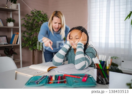 Mother scolding child about homework causing stress and frustration 138433513