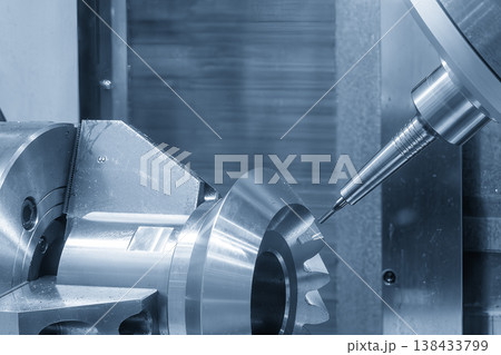 Advanced 5-axis CNC milling machine cutting a high-precision metal gear using a flat nose end mill tool. Advanced 5-axis CNC milling machine cutting a high-precision metal gear using a flat nose end mill tool. 138433799