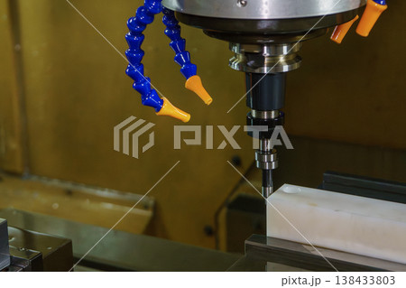 Precision work centering setup on a CNC milling machine using a mechanical edge finder tool for accurate alignment. 138433803