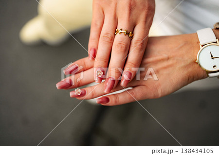 Woman's hands showing manicure with elegant nail art 138434105