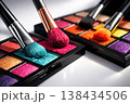 Close-up of vibrant eyeshadow palettes with makeup brushes ready for application 138434506
