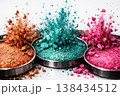 Explosion of vibrant glitter eyeshadows in copper, teal, and pink shades 138434512