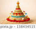 Thai Songkran sand pagoda decorated with flags and flowers on a beach 138434515