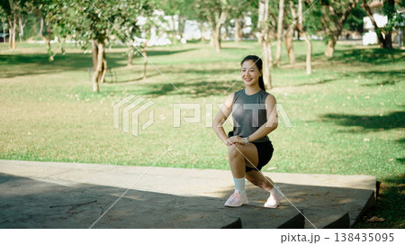 Female athlete doing lunges on stone steps, focused on warm up training 138435095