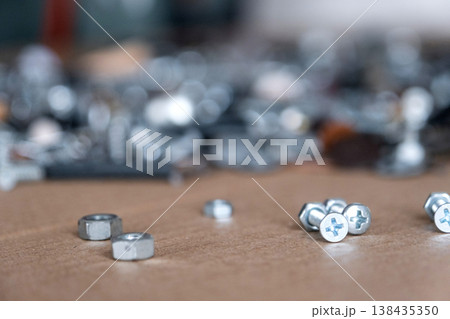 Metal nuts and bolts, manufacturing elements for repair, construction, fixing, maintenance, industrial production and hardware installation work. Metal nuts and bolts, manufacturing elements for repair, construction, fixing, maintenance, industrial production and hardware installation work. 138435350