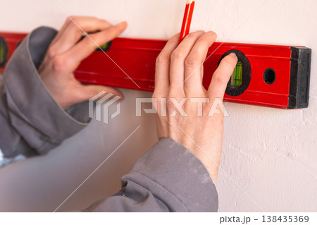 Marking with a spirit level, accurate measurement for wall installation, construction layout, preparation for mounting and renovation works. Marking with a spirit level, accurate measurement for wall installation, construction layout, preparation for mounting and renovation works. 138435369