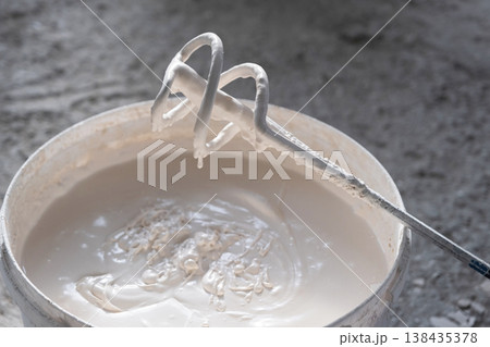 Preparation of plaster compound with electric mixer, uniform putty mixing, renovation stage, repair work, tools for construction finishing. 138435378