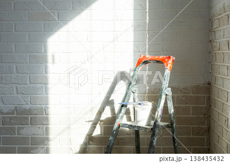 Interior wall repair, painting preparation, stepladder, paint supply, workspace for room improvement and home decor, construction finish. 138435432