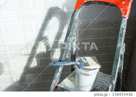Painting supply kit, stepladder and paint bucket for interior renovation, prepping walls for home decoration and finishing, room impression improvement. Painting supply kit, stepladder and paint bucket for interior renovation, prepping walls for home decoration and finishing, room impression improvement. 138435436
