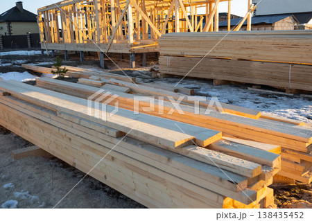Timber beams, planks and elements for house construction, site material storage, foundation work, carpentry, support parts, wooden frame structure preparation. Timber beams, planks and elements for house construction, site material storage, foundation work, carpentry, support parts, wooden frame structure preparation. 138435452