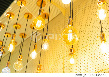 Edison retro light bulbs arrangement, designer ceiling lighting in store, vintage filament lamp decor, modern shop window, interior illumination accent. Edison retro light bulbs arrangement, designer ceiling lighting in store, vintage filament lamp decor, modern shop window, interior illumination accent. 138435540