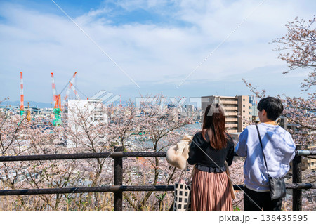 Couple view pink cherry sakura with Fukuoka city in springtime 138435595