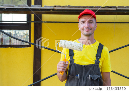 Portrait of builder with paint roller, home painting, at-home repairs, handyman services, private renovation business, DIY equipment kit, wall improvement. 138435850