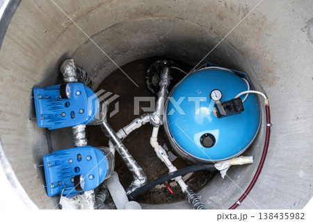 Installed equipment in artesian water well: pressure tank, filtration system, water pump, plumbing for house water supply, clean well solution. Installed equipment in artesian water well: pressure tank, filtration system, water pump, plumbing for house water supply, clean well solution. 138435982