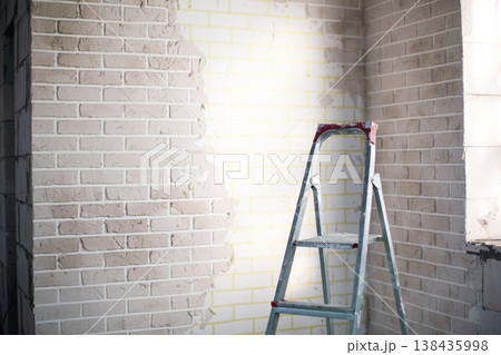Home interior renovation, wall finishing process, stepladder for ceiling and wall works, room preparation, construction and indoor repair projects. Home interior renovation, wall finishing process, stepladder for ceiling and wall works, room preparation, construction and indoor repair projects. 138435998