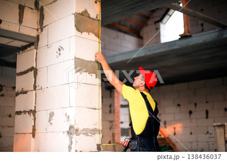 Professional takes window measurements, construction survey, size and fit check, preparing space for installation, window and door frame layout planning. 138436037