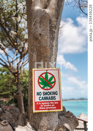 No smoking cannabis warning sign attached to tree near tropical beach on Koh Samui Thailand No smoking cannabis warning sign attached to tree near tropical beach on Koh Samui Thailand 138436226