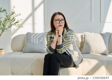 Mature sad woman experiencing stress, mental and physical pain, at home Mature sad woman experiencing stress, mental and physical pain, at home 138436647