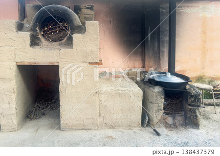 Rustic wood-burning stove sits outdoors Rustic wood-burning stove sits outdoors 138437379