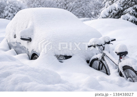 A car and a bicycle covered with deep snow in winter. 138438027