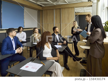 Business speaker facilitating corporate team workshop in modern office classroom Business speaker facilitating corporate team workshop in modern office classroom 138438174
