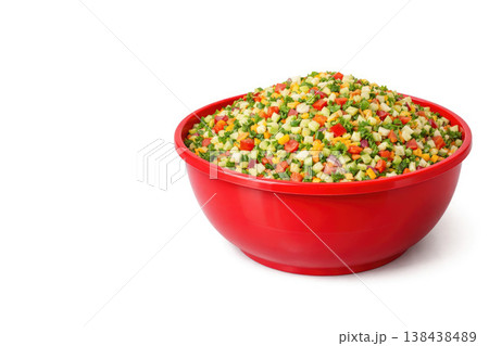 Red bowl with sliced vegetable salad on a light background. Space for text. 138438489