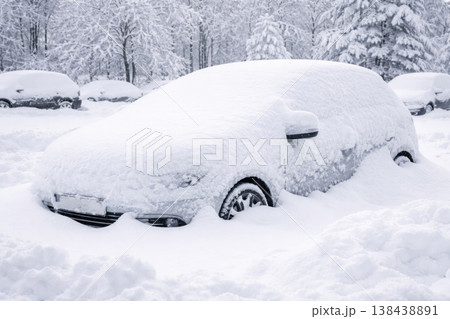 A car completely covered with snow in a winter parking lot. A car completely covered with snow in a winter parking lot. 138438891