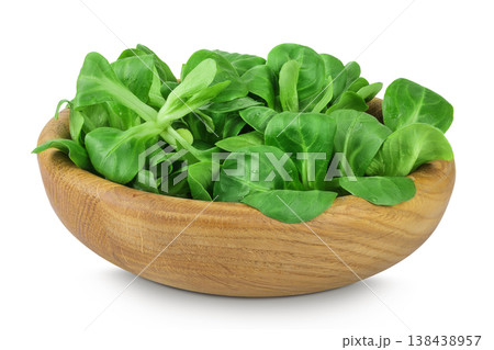 Valerian leaves salad. Corn salad in wooden bowl isolated on white backgrounds. Lettuce salad. Valerian leaves salad. Corn salad in wooden bowl isolated on white backgrounds. Lettuce salad. 138438957
