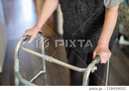 Senior woman using a walker for mobility support Senior woman using a walker for mobility support 138439032