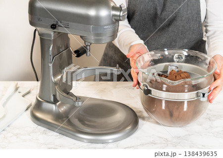 Stand mixer with butter, brown sugar, and other ingredients for Pale Gingerbread Cookies with Subtle Spice Flavor. Glass bowl on the mixer is partially filled. Stand mixer with butter, brown sugar, and other ingredients for Pale Gingerbread Cookies with Subtle Spice Flavor. Glass bowl on the mixer is partially filled. 138439635
