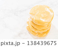 Close-up view of Classic Sugar Cookie Dough wrapped in plastic wrap, prepared for chilling in the refrigerator. This step ensures the dough firms up, making it easier to roll and cut for baking. 138439675