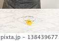 Freshly grated lemon zest in a small glass bowl, ready to infuse a citrusy flavor into lemon spritz cookies. 138439677