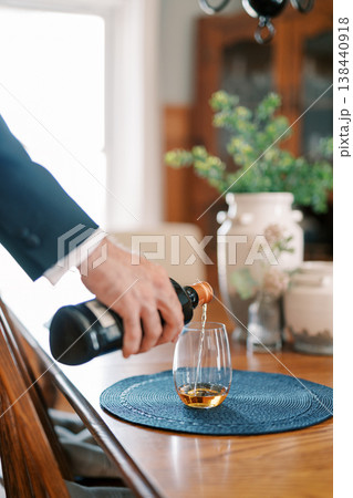 Executive Pouring Whiskey At Dining Table 138440918