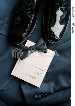 Groom Detail Flatlay With Navy Suit And Invitation 138440952