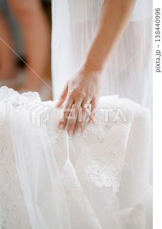 Bride Smoothing Lace Gown During Prep Bride Smoothing Lace Gown During Prep 138440996