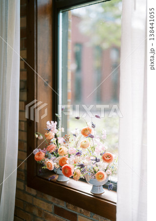 Peach And Cream Flowers Adorn Windowsill With Natural Light Peach And Cream Flowers Adorn Windowsill With Natural Light 138441055