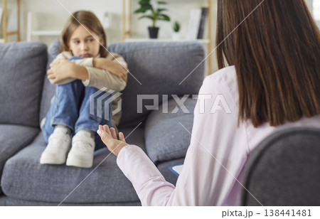 Psychologist working with upset child boy trying to help with his problem in office. Psychologist working with upset child boy trying to help with his problem in office. 138441481
